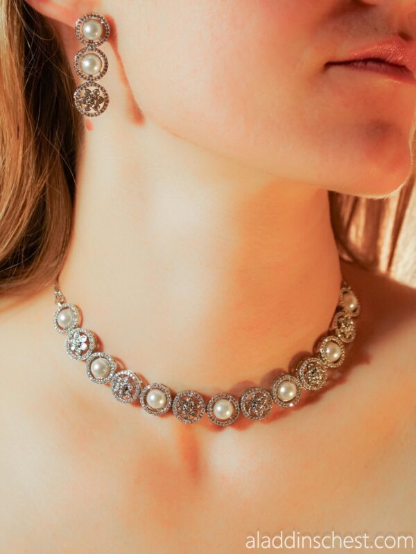 Woman wearing pearl and diamond jewelry set.