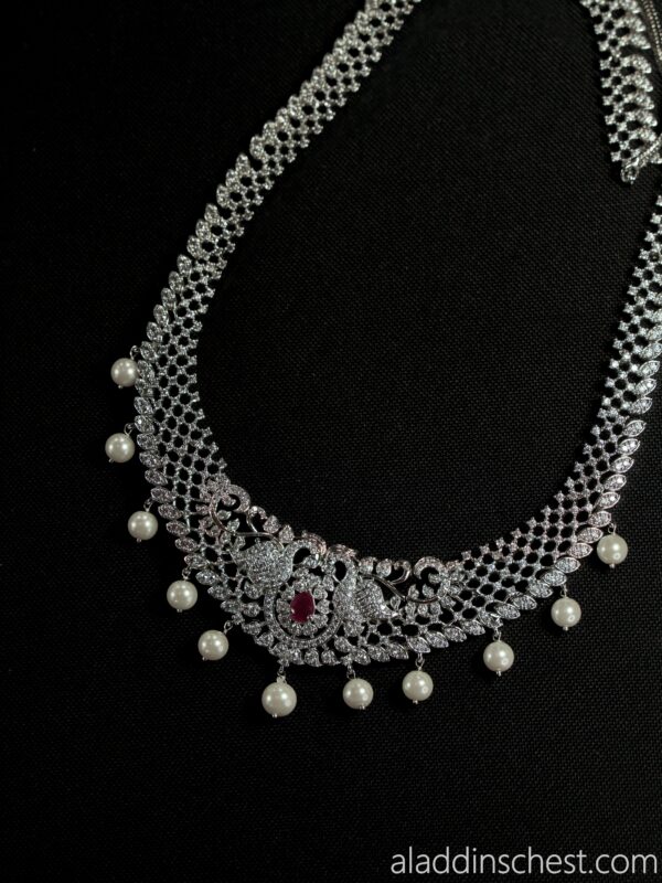 Elegant silver necklace with pearls and gemstones.