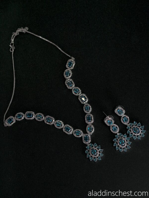 Elegant gemstone necklace and earrings set on display.