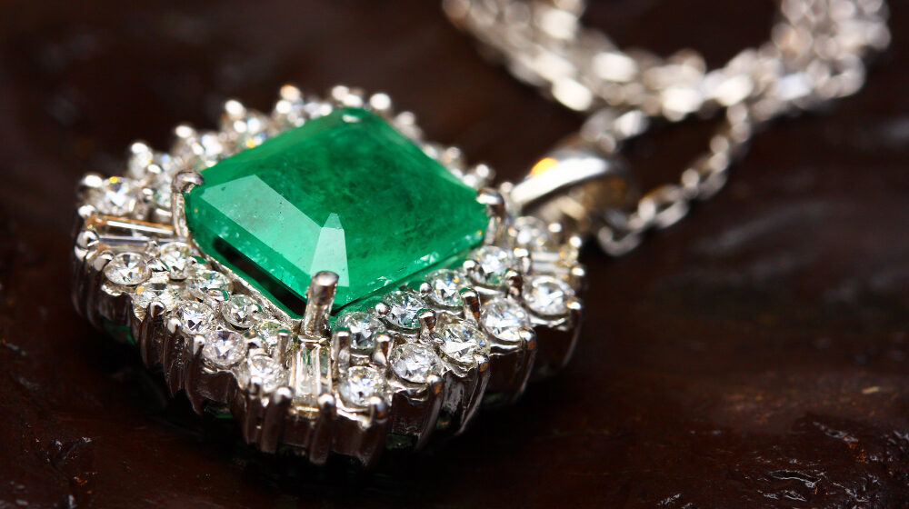 Emerald pendant with diamond accents on chain