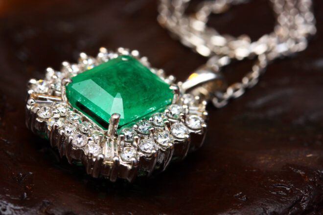 Emerald pendant with diamond accents on chain
