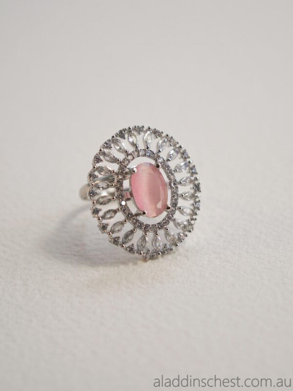 Pink gemstone ring with intricate silver design