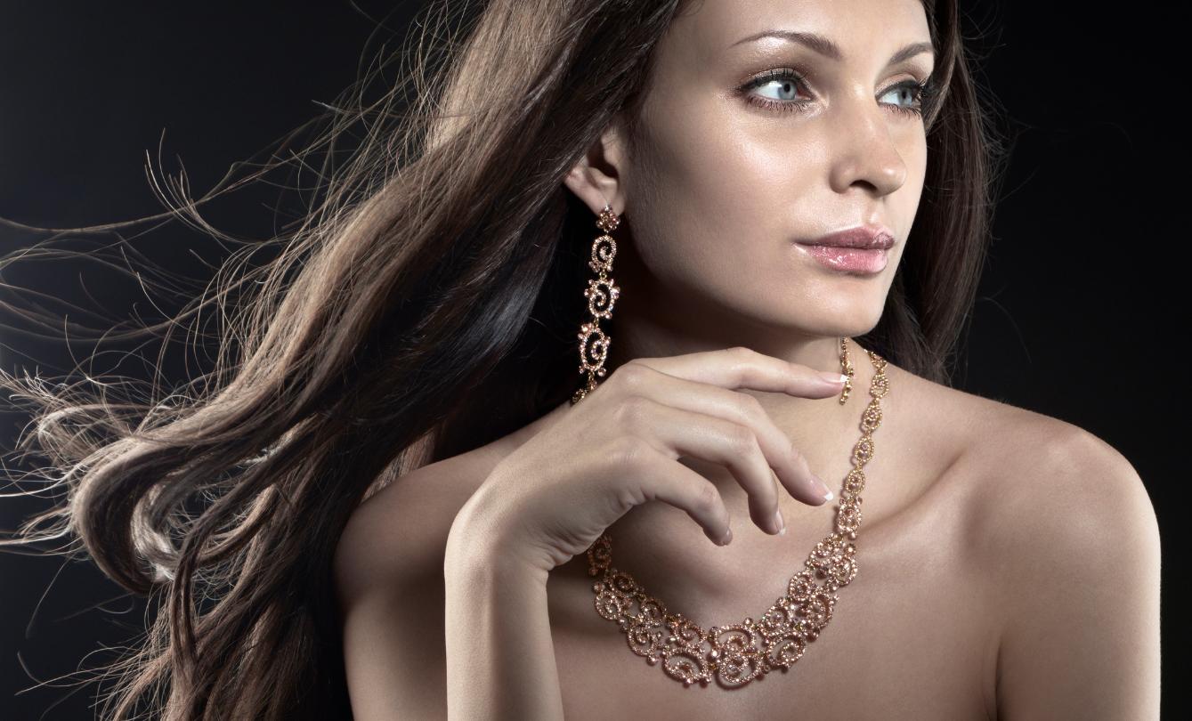 Woman wearing elegant gold jewelry.
