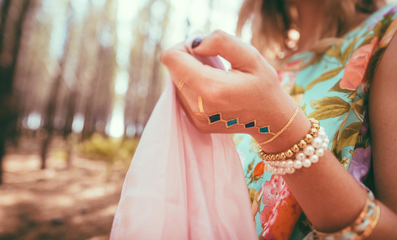 Woman wearing colorful bracelets in forest