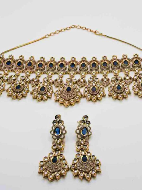 Gold and blue gemstone necklace with matching earrings.