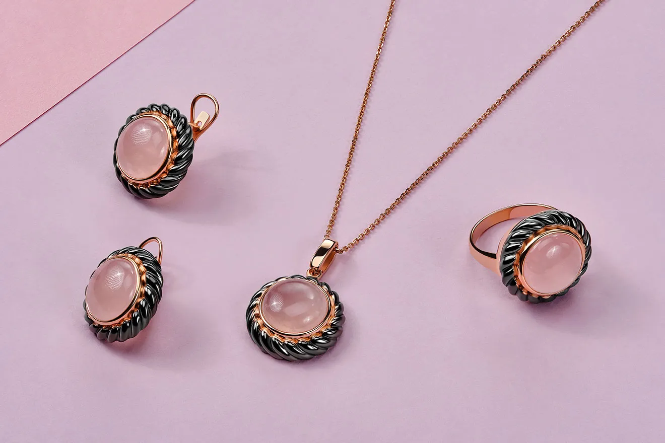 Rose quartz jewelry set on pink background