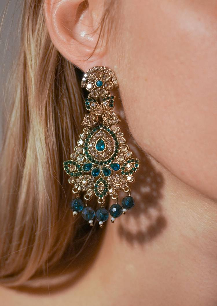 Close-up of ornate blue gemstone earring